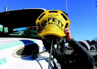 safety mirror mitt being put on a truck mirror