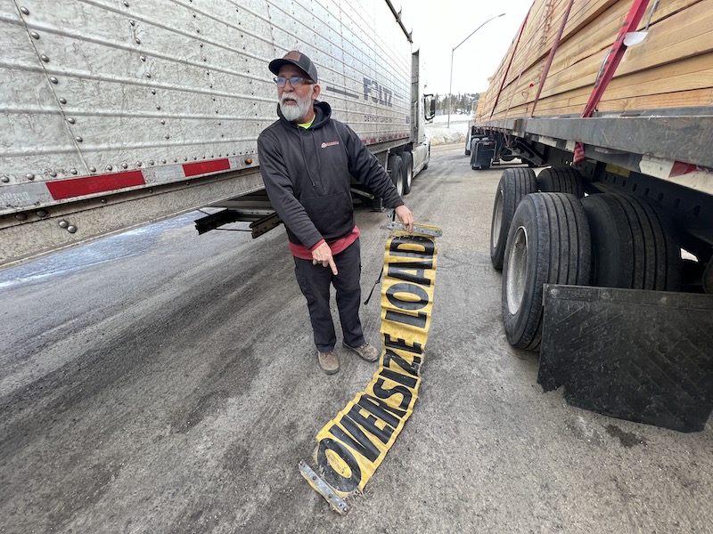 Leonel Corado with his 10-year-old Ms. Carita SafeTruck OVERSIZE LOAD vinyl banner