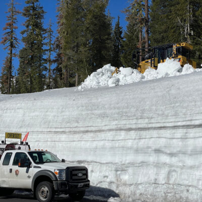A National Park Service Bulldozer on a snowbank above the Pilot Car