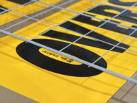 An OVERSIZE LOAD banner drying on a rack after printing