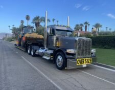 Truck hauling a 950M Wheel Loader