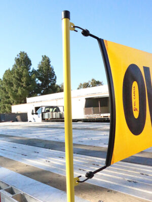 banner mount bracket on a flatbed trailer with a bungee oversize load banner