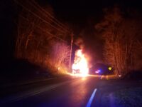 truck engulfed in flame on a road