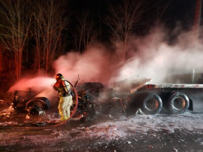 fire fighter working on putting out the truck fire.