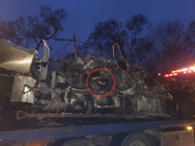 red foxfire light in the charred remains of the truck is still on 