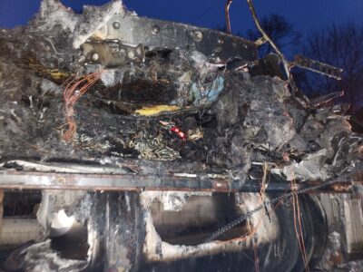 close up of a red foxfire light still on in the remains of the truck