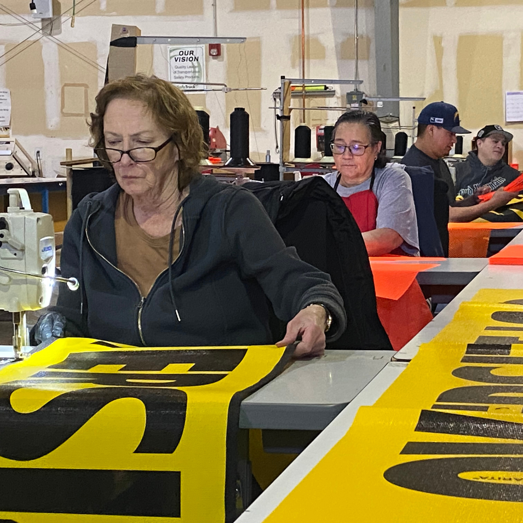 Finishing Department Sewing a banner in our Finishing Department