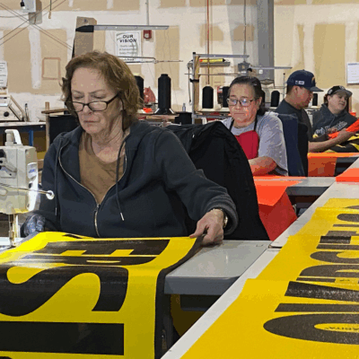 Finishing Department Sewing a banner in our Finishing Department